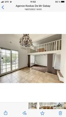 a large room with a chandelier and a staircase at villa matama in Cannes
