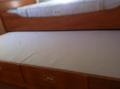 two bunk beds with white sheets on top of them at villa matama in Cannes