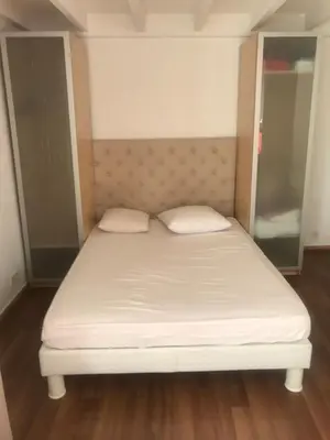 a bed in a room with a white mattress at villa matama in Cannes