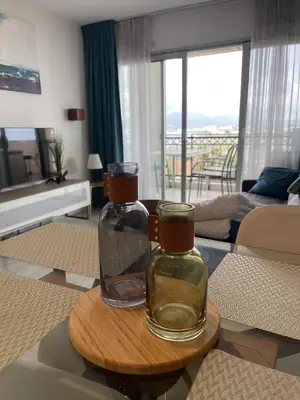 a living room with two glass vases on a table at Cannes Beach Residence vue mer et pisicne in Cannes