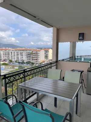 a table and chairs on a balcony with a view at Cannes Beach Residence vue mer et pisicne in Cannes