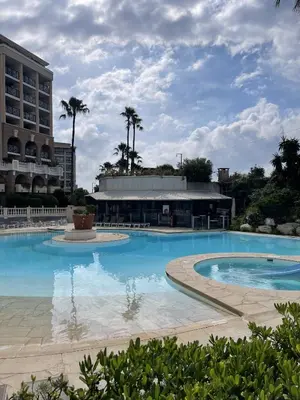 a large swimming pool in front of a building at Cannes Beach Residence vue mer et pisicne in Cannes