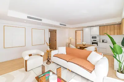 a living room with a couch and a table at REF 2011 - Cannes - Apartment for rent in Cannes