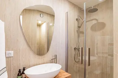 a bathroom with a sink and a shower with a mirror at REF 2011 - Cannes - Apartment for rent in Cannes