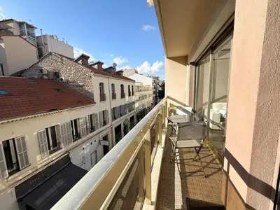 a balcony of a building with a chair on it at 25m2 - Coeur De Ville, Vue mer in Cannes