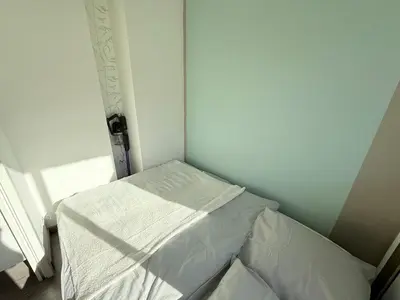 a small room with a bed in the corner at 25m2 - Coeur De Ville, Vue mer in Cannes