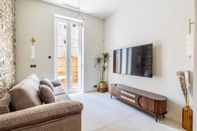 a living room with a couch and a tv on a wall at Magnificent apartment - AC-1BR-4P- Cannes in Cannes