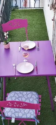 a purple table and chair with plates and utensils at Belle vue mer in Cannes