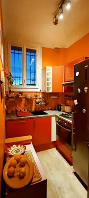 a kitchen with orange cabinets and a plate on a table at Belle vue mer in Cannes