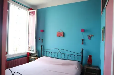 a blue bedroom with a bed in a room at Belle vue mer in Cannes