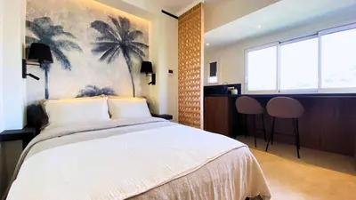 a bedroom with a large bed with a painting on the wall at Cannes Croisette in Cannes