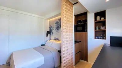 a bedroom with a white bed and a tv at Cannes Croisette in Cannes