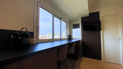 a room with a desk with a window and chairs at Cannes Croisette in Cannes
