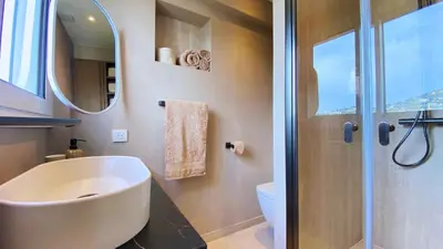 a bathroom with a sink and a shower with a mirror at Cannes Croisette in Cannes