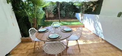 a table and chairs sitting on a patio at Élégant cocon sur la croisette parking terrasse et jardin in Cannes