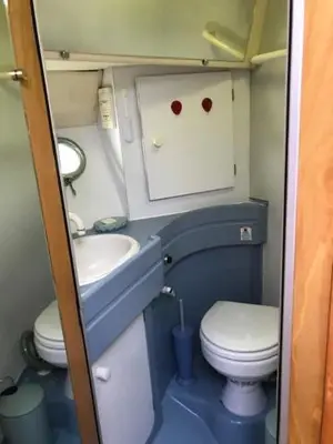 a small bathroom with a sink and a toilet at une place au soleil in Cannes
