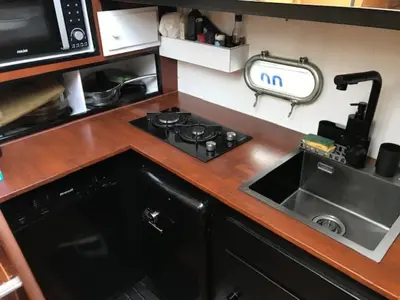 a kitchen counter with a stove and a sink at une place au soleil in Cannes