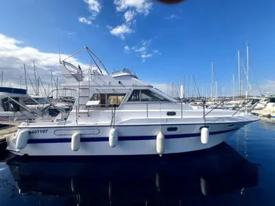 a white boat is docked in a harbor at une place au soleil in Cannes