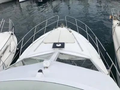 a white boat is docked in the water at une place au soleil in Cannes