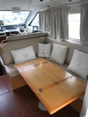 a living room with a wooden table in a boat at une place au soleil in Cannes