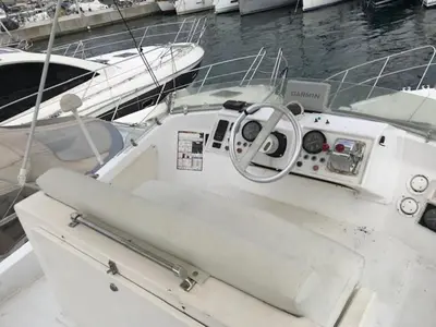 a white boat is docked in the water at une place au soleil in Cannes
