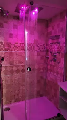 a purple bathroom with a shower with pink lighting at Beachfront 4 - 6 people 2 swimming pool in Cannes