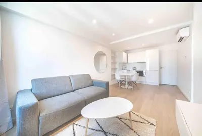 a living room with a couch and a table at Cannes Hoche Croisette Sublime T2 in Cannes