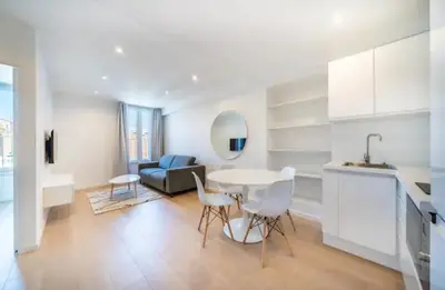 a kitchen and living room with a table and chairs at Cannes Hoche Croisette Sublime T2 in Cannes