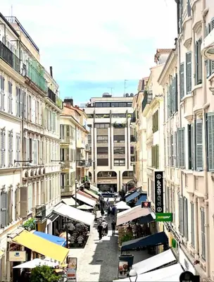 a city street with buildings and people walking down the street at Cannes Hoche Croisette Sublime T2 in Cannes