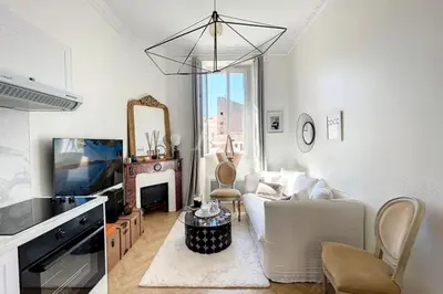 a living room with a white couch and a mirror at Le Barocco - Calm - Hypercentre - Cosy in Cannes