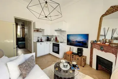a living room with a couch and a fireplace at Le Barocco - Calm - Hypercentre - Cosy in Cannes