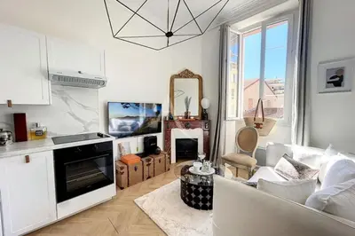 a living room with a couch and a table at Le Barocco - Calm - Hypercentre - Cosy in Cannes
