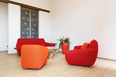 a room with orange and red chairs and a table at RARE-Superbe appt Suquet, jardin,6p,200m Croisette in Cannes