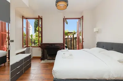 a bedroom with a white bed and a piano at RARE-Superbe appt Suquet, jardin,6p,200m Croisette in Cannes