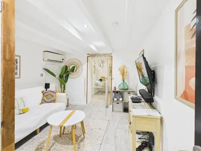 a white living room with a couch and a table at LE MIMOSA mignon en plein centre-ville, emplacement parfait pour votre séjour in Cannes
