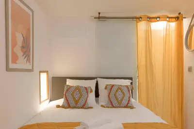 a bedroom with a bed with two pillows at LE MIMOSA mignon en plein centre-ville, emplacement parfait pour votre séjour in Cannes