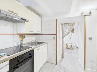 a kitchen with white cabinets and a sink at LE MIMOSA mignon en plein centre-ville, emplacement parfait pour votre séjour in Cannes