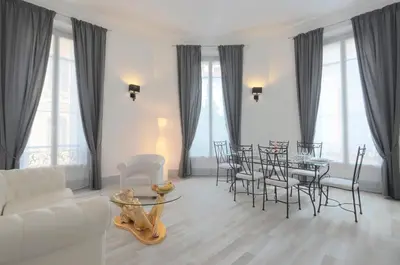 a living room with a table and chairs at Residence Michel Ange in Cannes