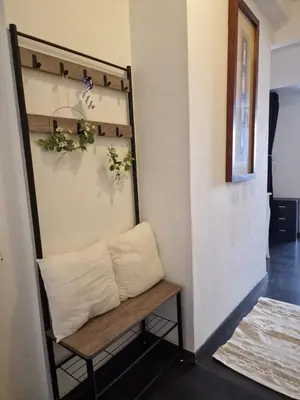 a bench in the corner of a room with plants at Bright apartment 10 minutes from Cannes in Le Cannet