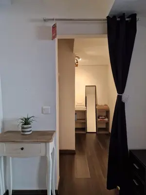 a room with a desk and a room with a mirror at Bright apartment 10 minutes from Cannes in Le Cannet