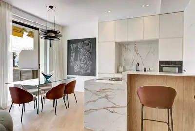 a kitchen with a dining table and chairs at Luxury Apt Cannes Croisette sea view with terrasse in Cannes