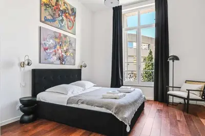a bedroom with a large bed and a window at C023 Magnifique appartement 3 chambres dans Cannes in Cannes
