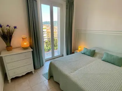 a bedroom with a bed and a large window at Villa Faustina by Connexion in Cannes