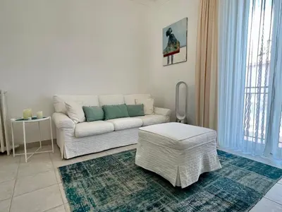 a living room with a white couch and a table at Villa Faustina by Connexion in Cannes