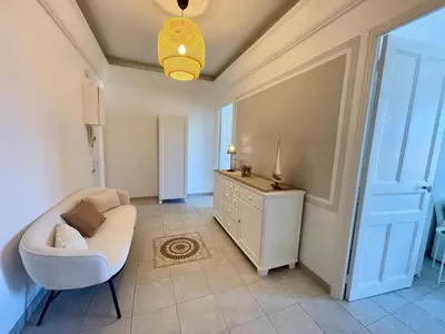 a living room with a white couch and a chair at Villa Faustina by Connexion in Cannes