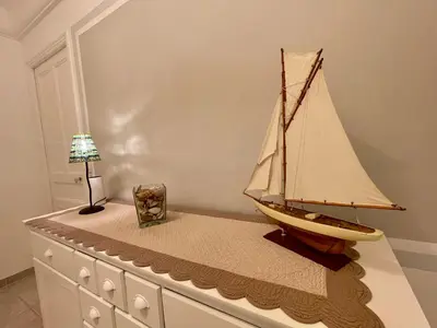 a model of a boat sitting on top of a dresser at Villa Faustina by Connexion in Cannes
