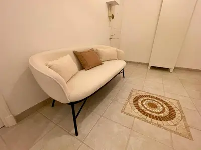 a white chair with two pillows on it in a room at Villa Faustina by Connexion in Cannes