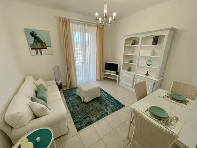 a living room with a couch and a table at Villa Faustina by Connexion in Cannes