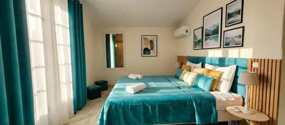 a bedroom with a blue bed with a blue blanket at Villa Olimp in Super Cannes with sea view in Le Cannet