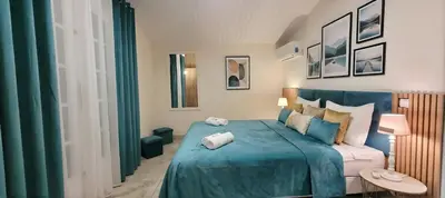 a bedroom with a blue bed with towels on it at Villa Olimp in Super Cannes with sea view in Le Cannet